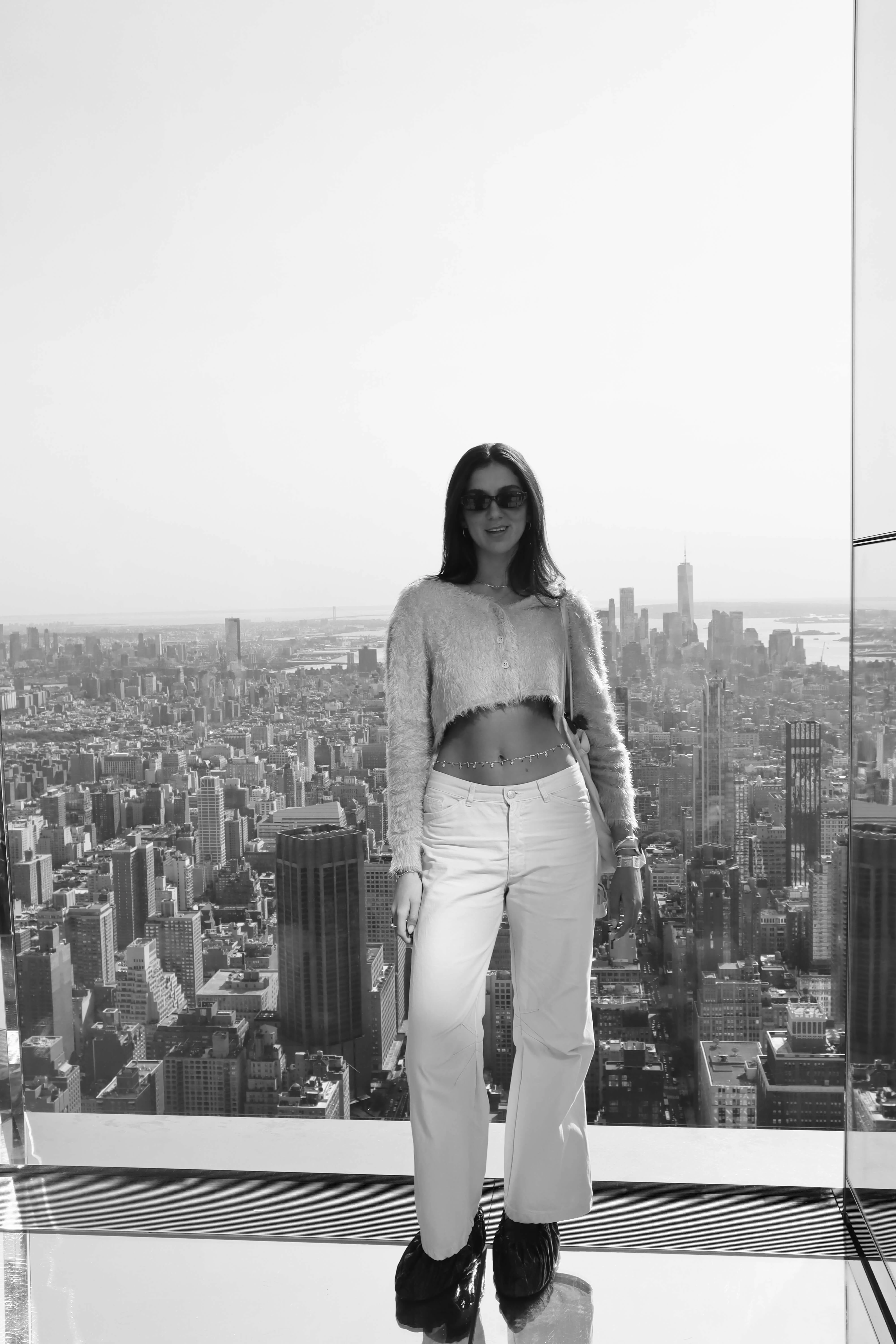 Hila Gantz on a rooftop with a city skyline behind her
