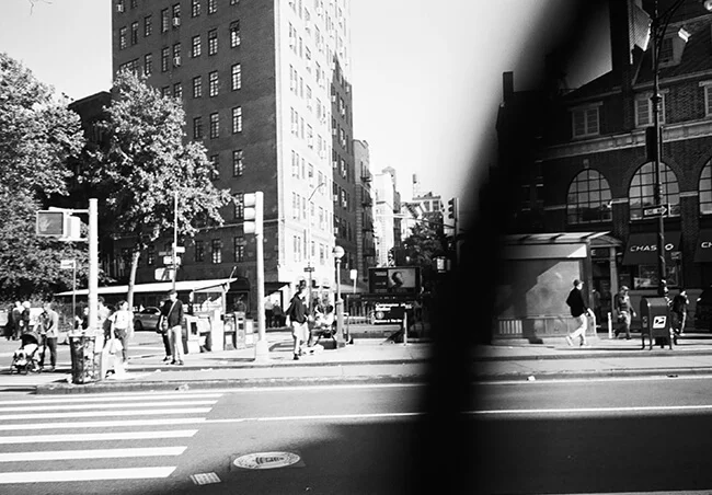 Motion-blurred city street scene with high-rise buildings